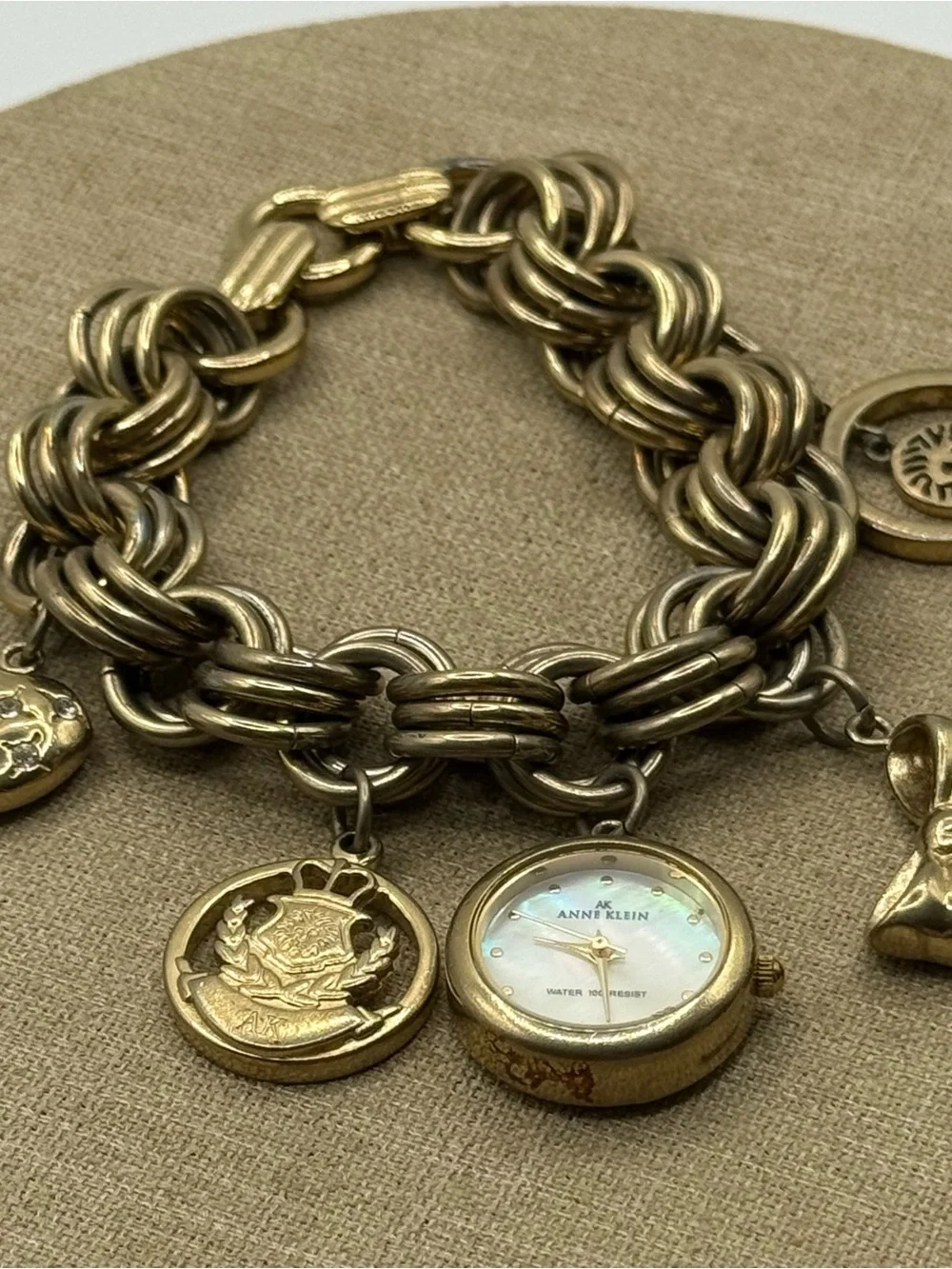Anne Klein Gold Charm Bracelet Watch with Mother-of-Pearl Dial & Bow Charm